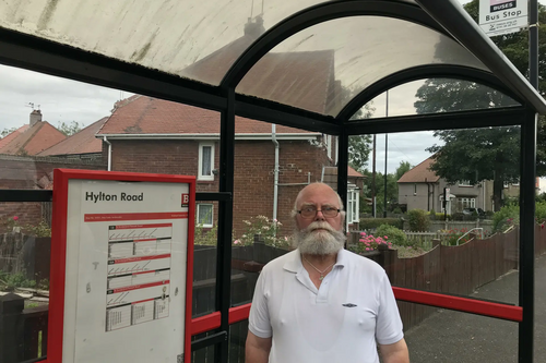 Councillor George Smith at a bus stop on Hylton Road